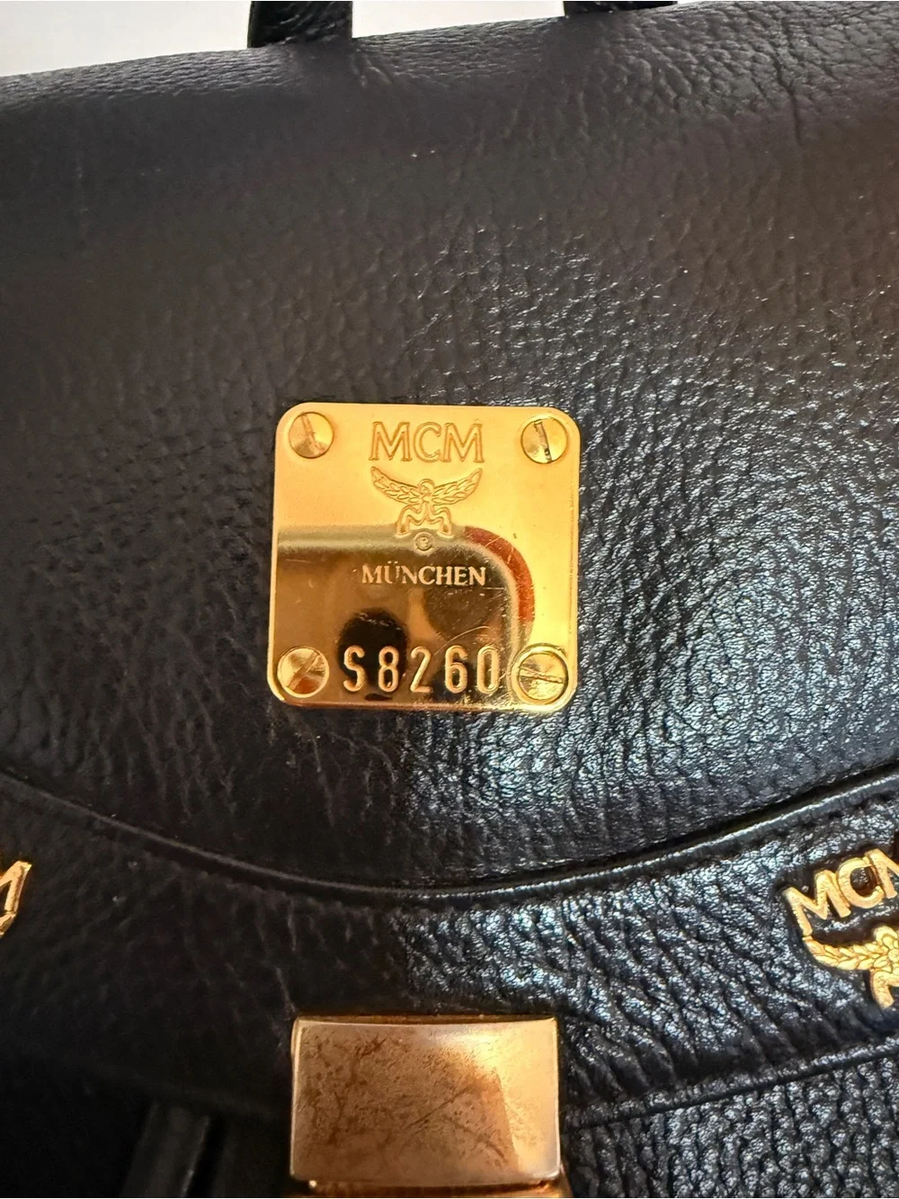 MCM Black Leather Backpack with Gold Accents and Front Pockets